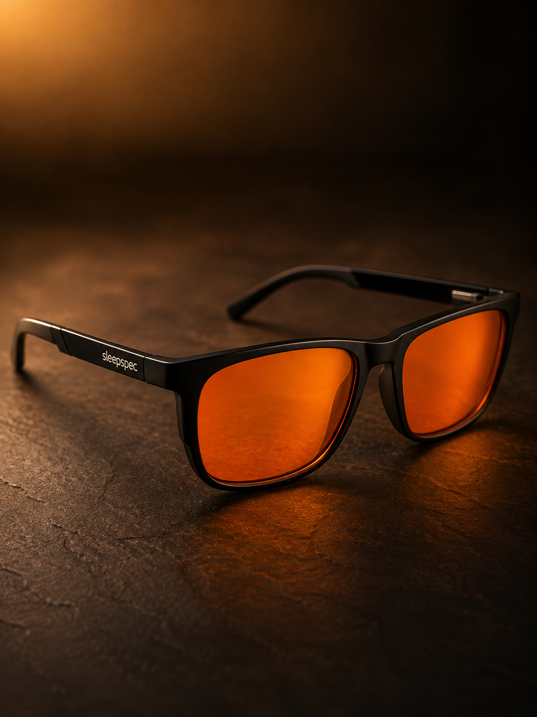 SleepSpec sleep glasses: a black TR90 frame with deep-amber lenses.