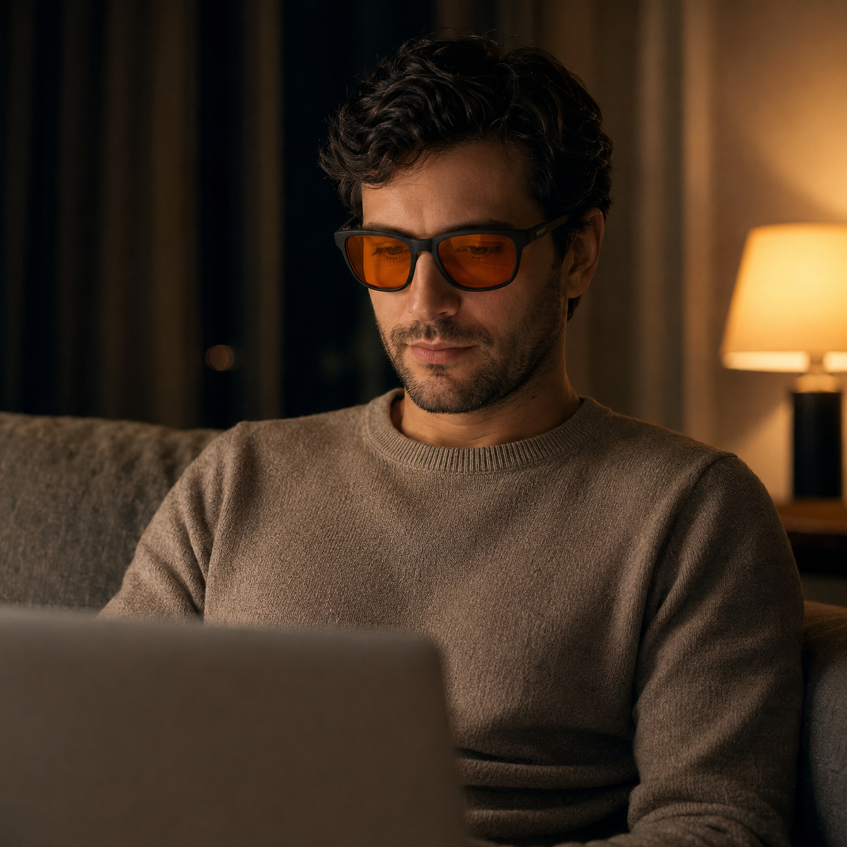 A person wearing SleepSpec glasses while continuing their usual evening screen time.